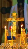Burning candles in the temple. Orthodox cross, crucifixion. The Christian religion and faith in God. Vertical video for shorts.
