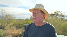 Older single lonely man wearing fedora hat sits outdoor pensive lost in thought. - Powered by Shutterstock - Get 15% off with code: PIKWIZARD15
