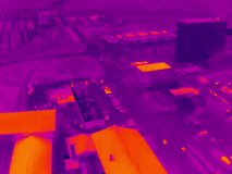 Aerial infrared thermal view of industrial zone with factories and warehouses, in purple and yellow hues