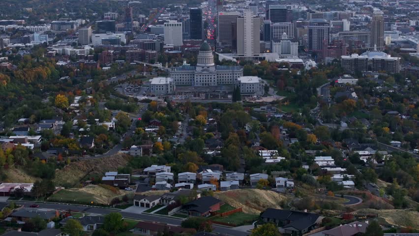 Utah State Capitol Building and cityscape at sunset, Salt Lake City in Utah, USA. Aerial tilt-up reveal