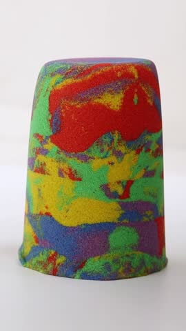 Kinetic sand of different colors red yellow green blue purple. Cutting kinetic colored sand.