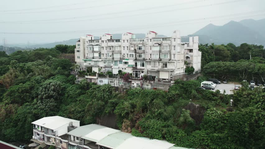 Residential Building In The Outskirts Of Taipei In Guandu, Taiwan. drone orbiting shot