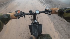 First person view cyclist on bike. Outdoor cycling. Person cycling on dirty, wet, dangerous road. Extreme drive. Mountain biker riding trails in forest. Point view man on bike. 