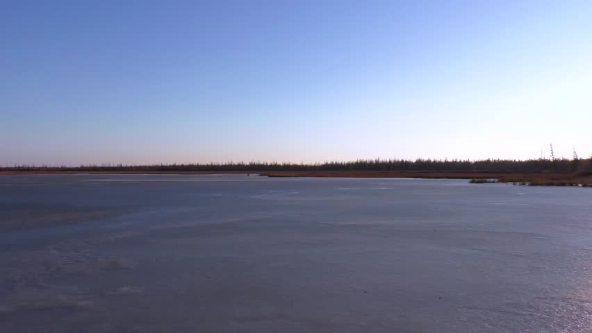The frozen lake. Landscape with a lake and bright sunlight