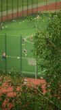 Kicking goals and camaraderie displayed with kids playing soccer in a blurred stadium vertical video