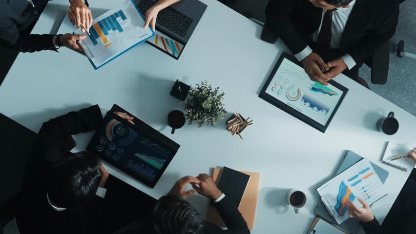 Top down aerial view businessman present marketing statistic graph to investor at meeting table. Group of diverse project manager analyze investment data while looking at financial chart. Directorate. Royalty-Free Stock Footage #3450291085