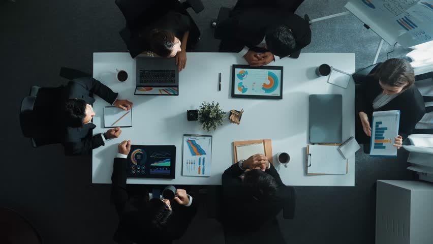 Top down aerial view of diverse business team listening manager present growth sales while giving a high five to encourage or motivate team. Group of people celebrate successful project. Directorate. Royalty-Free Stock Footage #3450318159
