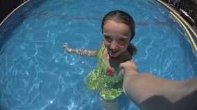 Little teenage girl taking selfie shots, diving & Playing in Swimming Pool - For videos about: swimming, pools, summer fun, vacation, getaways, underwater footage, kids, beating the heat, and exercise