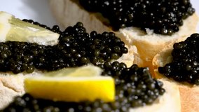 sandwiches with caviar and a slice of lemon macro video. An appetizer for those who love seafood