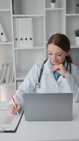 A healthcare professional is intently reading the results of patients' examinations and analyzes on a computer screen. An experienced doctor with an expression of satisfaction conducts a consultation Royalty-Free Stock Footage #3450409465
