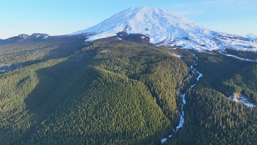 Morning light illuminates Mount St. Helens as it rises from the lush forests of Washington. Not far from both Seattle and Portland, this scenic, stratovolcano is still active.