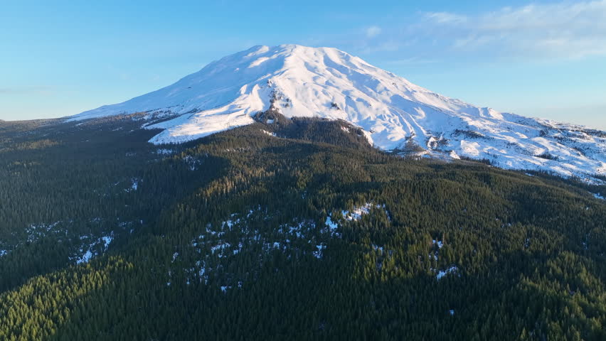 Morning light illuminates Mount St. Helens as it rises from the lush forests of Washington. Not far from both Seattle and Portland, this scenic, stratovolcano is still active.