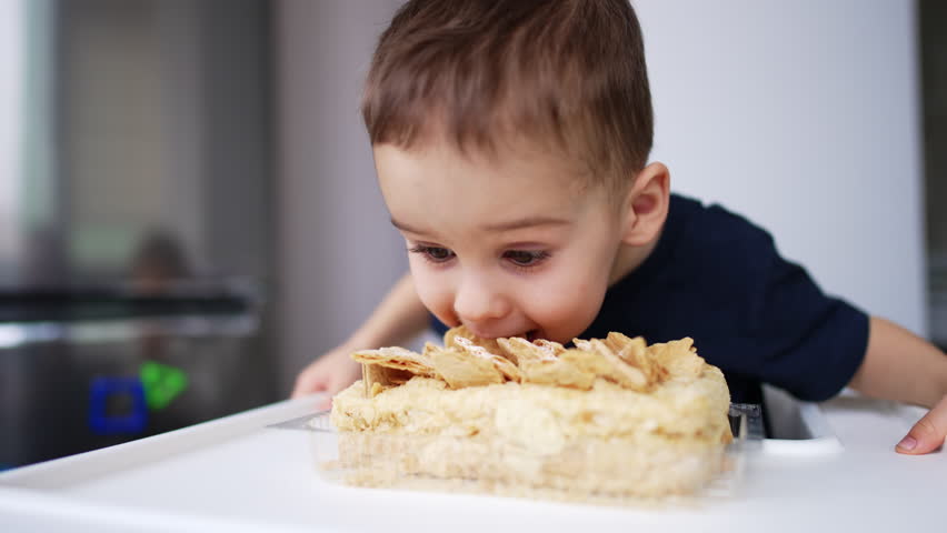 Funny cute boy eating yummy food. Delicious lunch having cheerful child. Royalty-Free Stock Footage #3450553459