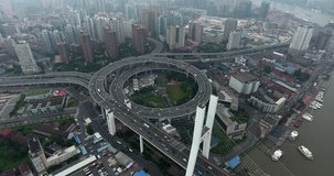 SHANGHAI, CHINA – JUNE 2016 : Aerial shot over Central Shanghai highway roundabout traffic at daytime
