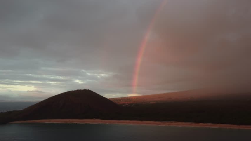 Epic aerial shot of a rainbow over beautiful South Maui beach, Maui County, Hawaii. The southern coast of Maui in Hawai
