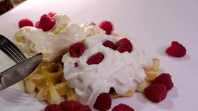 process of preparing sweet delicious waffles in electric waffle iron beat ingredients eggs flour add sugar close-up cooking show recipe. Breakfast with raspberries decorate A set of videos