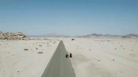 road in desert, Two Biker on Road view from sky with drone camera in the desert. Sky and Desert View.