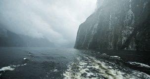 NEW ZEALAND – MARCH 2016 : Video shot from a boat at Milford Sound moving down fjord on a cloudy day