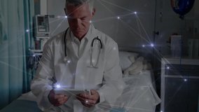 Animation of network of connections over caucasian male doctor using tablet. Global medicine, healthcare, connections and digital interface concept digitally generated video. - Powered by Shutterstock - Get 15% off with code: PIKWIZARD15