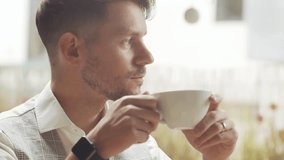 Businessman sitting and working in a cafe. Man using devices. Business and entrepreneurship concept. - Powered by Shutterstock - Get 15% off with code: PIKWIZARD15