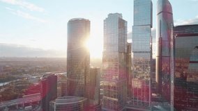 A sun set drone Aerial shot of skyscrapers of  business centre, 4K Ultra HD real time video. Urban scene of financial company office. Drone Camera moving slow forward buildings. Moscow skyline