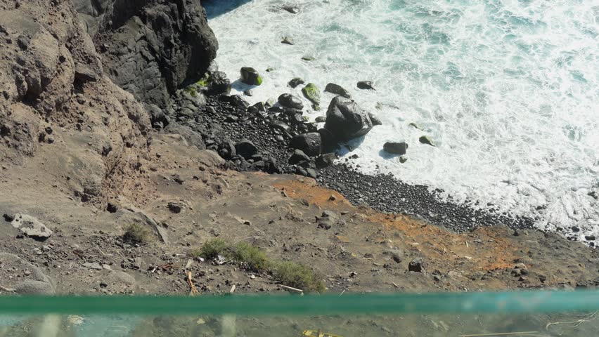 Fallen guard rails on rocky cliffside near Atlantic ocean in Tenerife Royalty-Free Stock Footage #3451097481