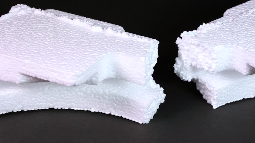 Crushed styrofoam on black background rotating