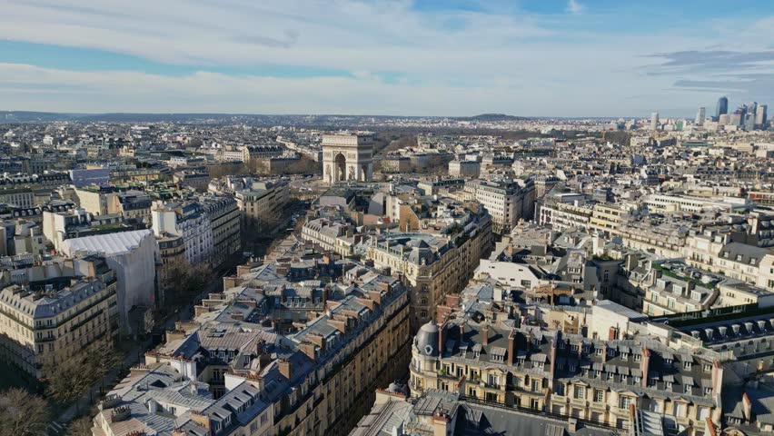 Drone flying over roofs of Paris with Triumphal arch or Arc de Triomphe in background, France. Aerial forward and sky for copy space Royalty-Free Stock Footage #3451294593
