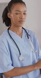 Vertical video of portrait of african american female physiotherapist. senior healthcare and medical physiotherapy treatment.