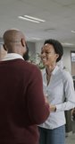 Vertical video of happy african american business people talking in slow motion. Global business, finances and office concept.