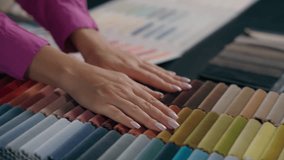 Close up female hands touching soft colorful fabric samples velvet fiber textile. Unrecognizable woman fashion designer moving palms across variety of color tone upholstery material furniture design - Powered by Shutterstock - Get 15% off with code: PIKWIZARD15