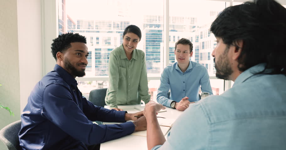 Business talk of four young professional team gathered in conference room to exchanging opinion, share solution, conferring at briefing. Negotiations, discuss agreement details, planning cooperation Royalty-Free Stock Footage #3451349583