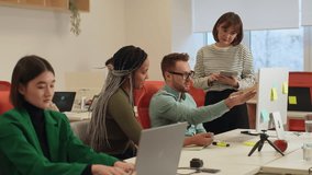 Professional male mentor or executive manager boss teaching female internes, explaining online work pointing at computer screen. Team leader supervisor training new worker instructing in modern office - Powered by Shutterstock - Get 15% off with code: PIKWIZARD15