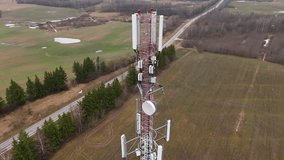 Cell site of telephone tower with 5G base station transceiver. Aerial view of telecommunication antenna mast. Aerial view of telecom antennas in the wild 4K drone footage. 