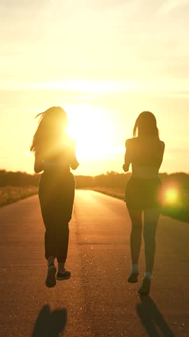 two friends running sunset, team group girls running sunset, silhouette athletic girls, teamwork young active sport athlete, achieves her goal, focused female athlete, club like-minded people Royalty-Free Stock Footage #3451517473