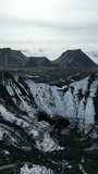 Aerial view Glacier landscape. Blue ice on the mountain. Climate Change and Global Warming. Ice Cave near Vik, Iceland, Katla. Vertical video 