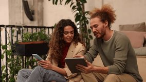 Young coworking coworkers meeting using digital tablet, young caucasian woman with curly hair with redhead man. - Powered by Shutterstock - Get 15% off with code: PIKWIZARD15
