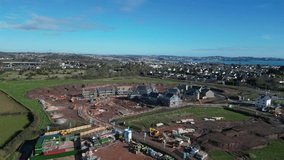 Paignton, Torbay, South Devon, England: DRONE VIEWS: A new build housing construction site on green belt land at White Rock on the outskirts of the town of Paignton (Clip 6).