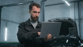 Adult man Caucasian male auto mechanic repairman using laptop checking car engine computer diagnostic transport maintenance in garage vehicle service station technician guy worker automobile factory - Powered by Shutterstock - Get 15% off with code: PIKWIZARD15