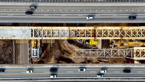 Highway road construction site. Building new bridges over the river in Kaunas, Lithuania. Aerial 4K top view footage of road currently under construction. 