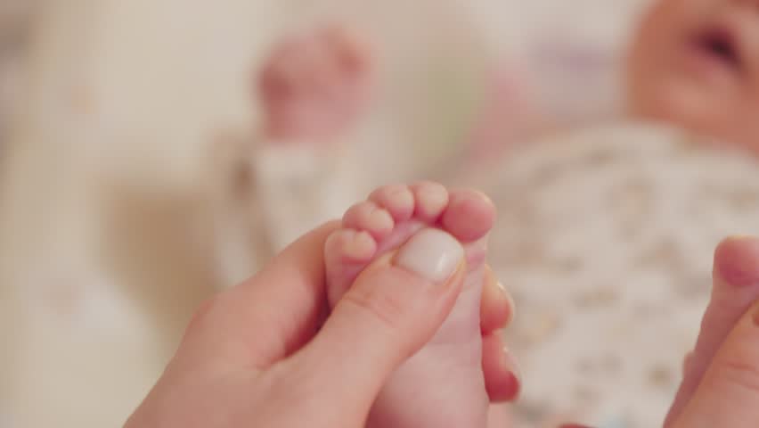 Tiny feet Toes Touched Gently During a Peaceful Afternoon Nap Time. Selective focus Royalty-Free Stock Footage #3451812323