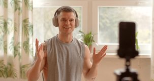 Fitness trainer greetings during online workout session at home. Utilizing technology as smartphones and video conferencing platforms, participants engage in virtual fitness sessions. Modern age life.