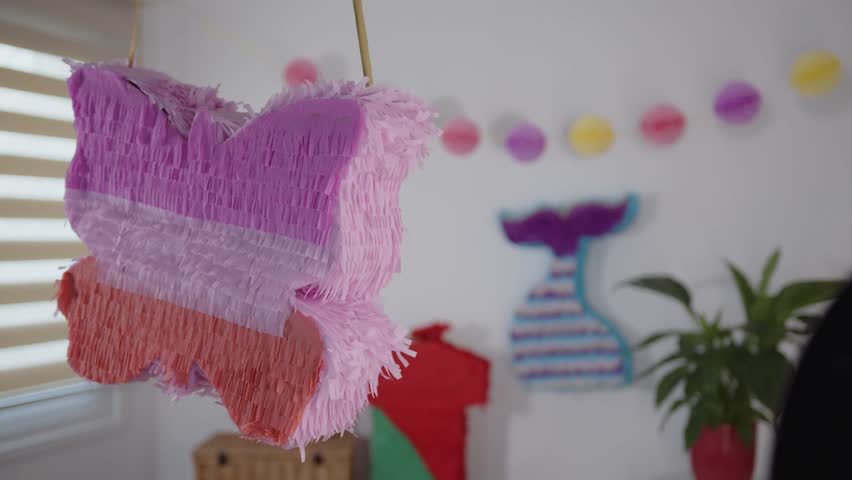 Mexican pinata decoration in bright colors hanging at Mexican fiesta celebration, Mexican tradition concept