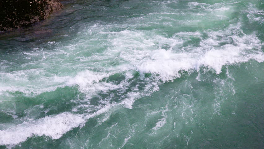 River stream rapids - fresh water torrent producing white froth and foam by powerful flow. Environmental protection and natural resources conservation. With sound.