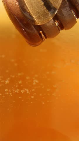 Honey close-up with a spoon for honey. Honey flows slowly. Entertaining ASMR video