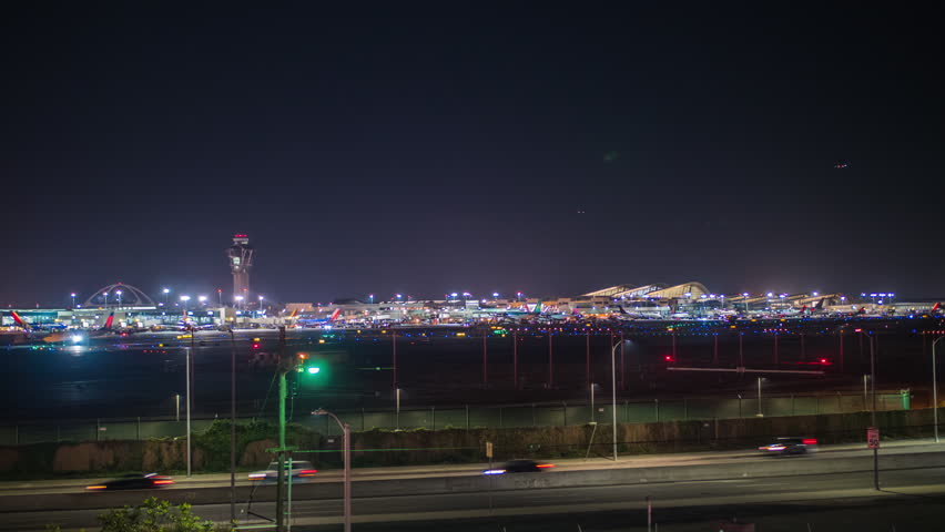 Timelapse of LAX airport with jet planes taking off at night