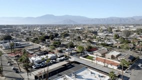 Neighborhood in Coachella, California with drone video moving in.