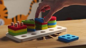 Hands skillfully manipulate colorful construction pieces, crafting amazing shapes and structures. Perfect video for inspiring creativity and play.