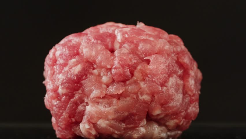 Cooking American fat smash burger on grill close-up. Beef or pork cutlet smashing by burger press. The chef in kitchen of the restaurant making cutlets for burgers - smash burger beefsteak. Fast and
