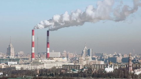 Aerial view of Moscow with smoke goes from tubes of power plant in cold day at winter